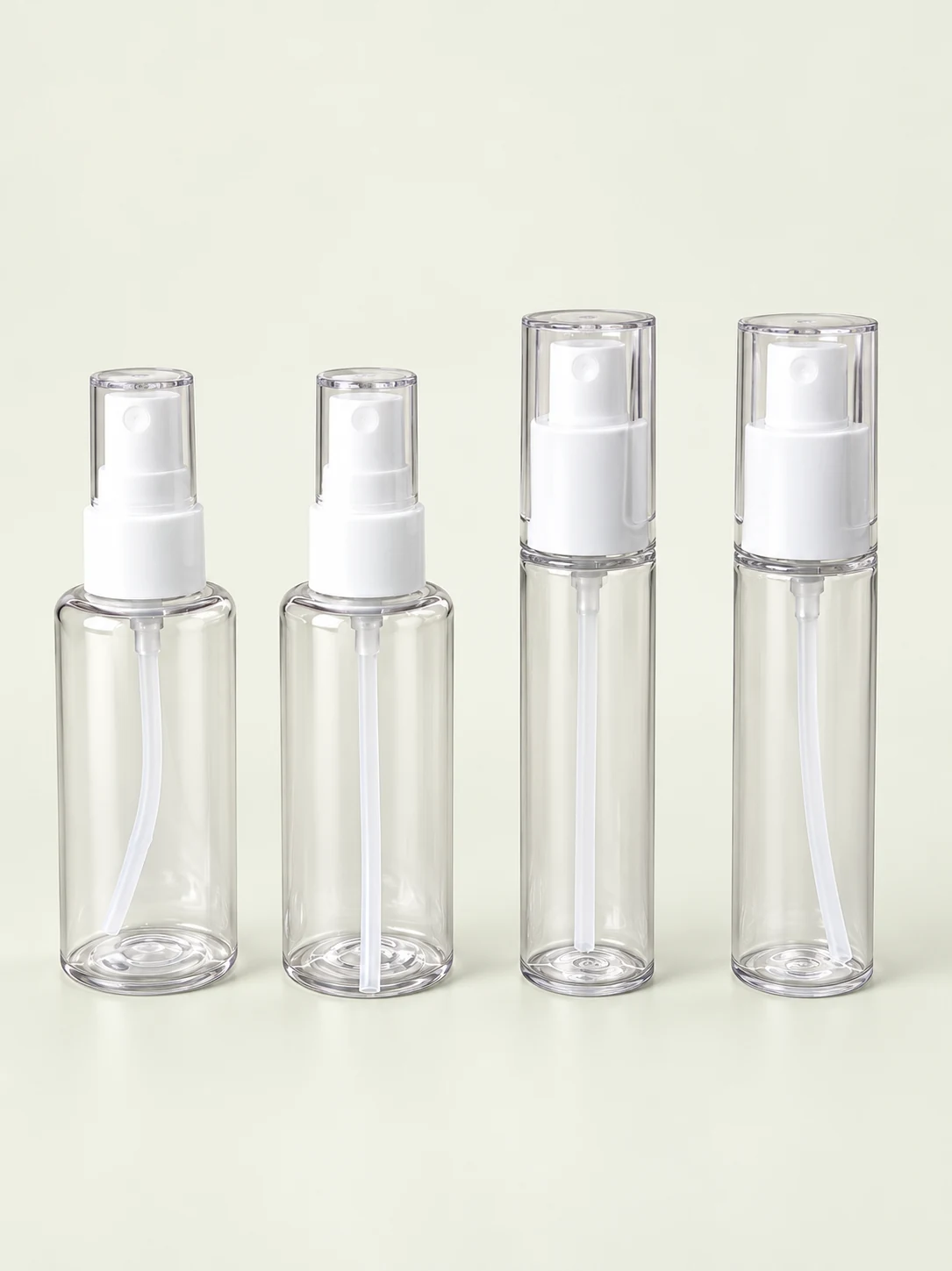 Four white spray assemblies mounted on clear sample bottles