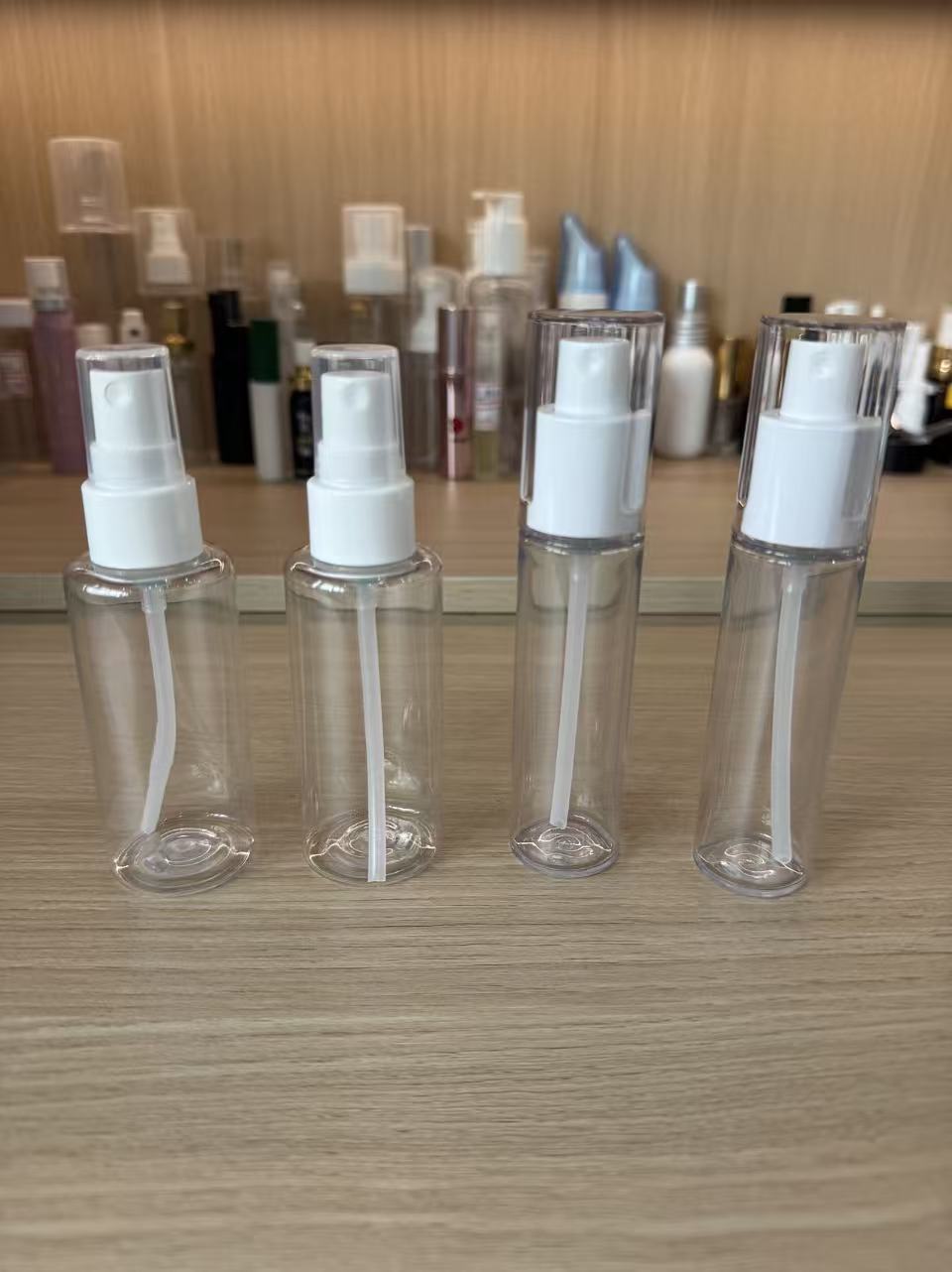 White spray assemblies mounted on transparent sample bottles
